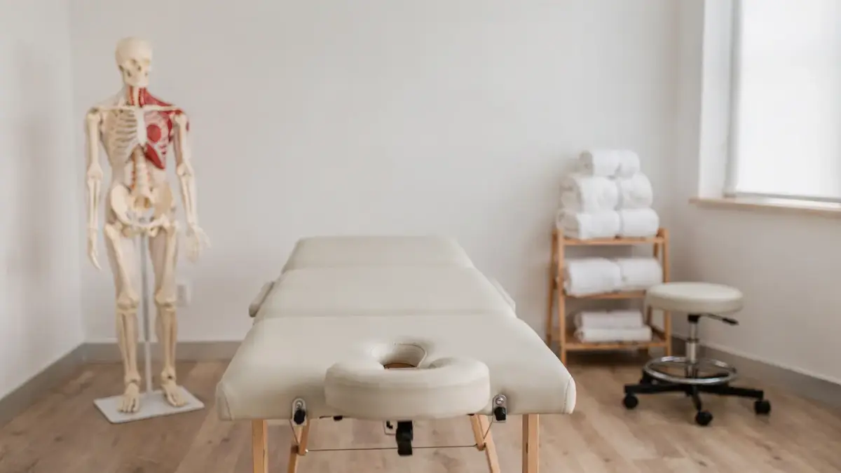Osteopathie-Studienlage in einer hellen Praxis mit Behandlungsliege und Anatomiemodell